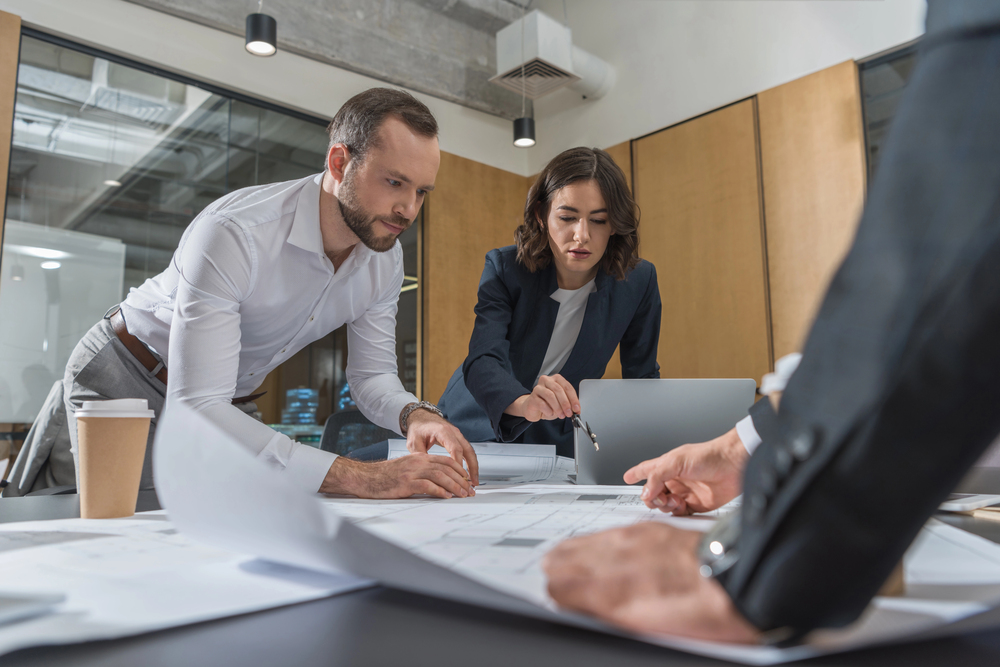 Colleagues discussing the integration of AI in their advertising efforts