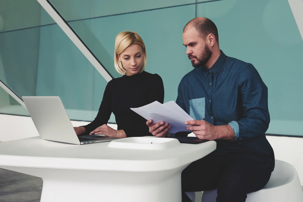 Colleagues studying AI-powered advertising campaigns
