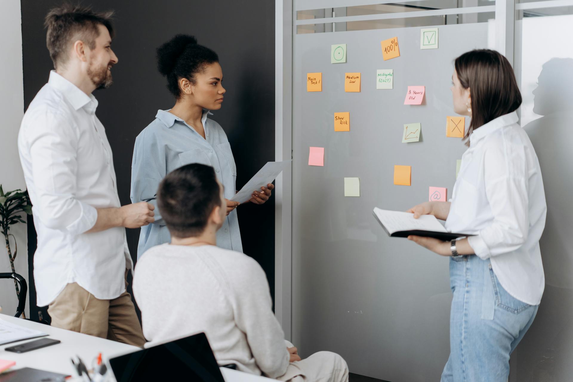 From Syllabus to Sales Page: Write Copy That Converts image Team brainstorming with colorful sticky notes on glass wall during page structure planning
